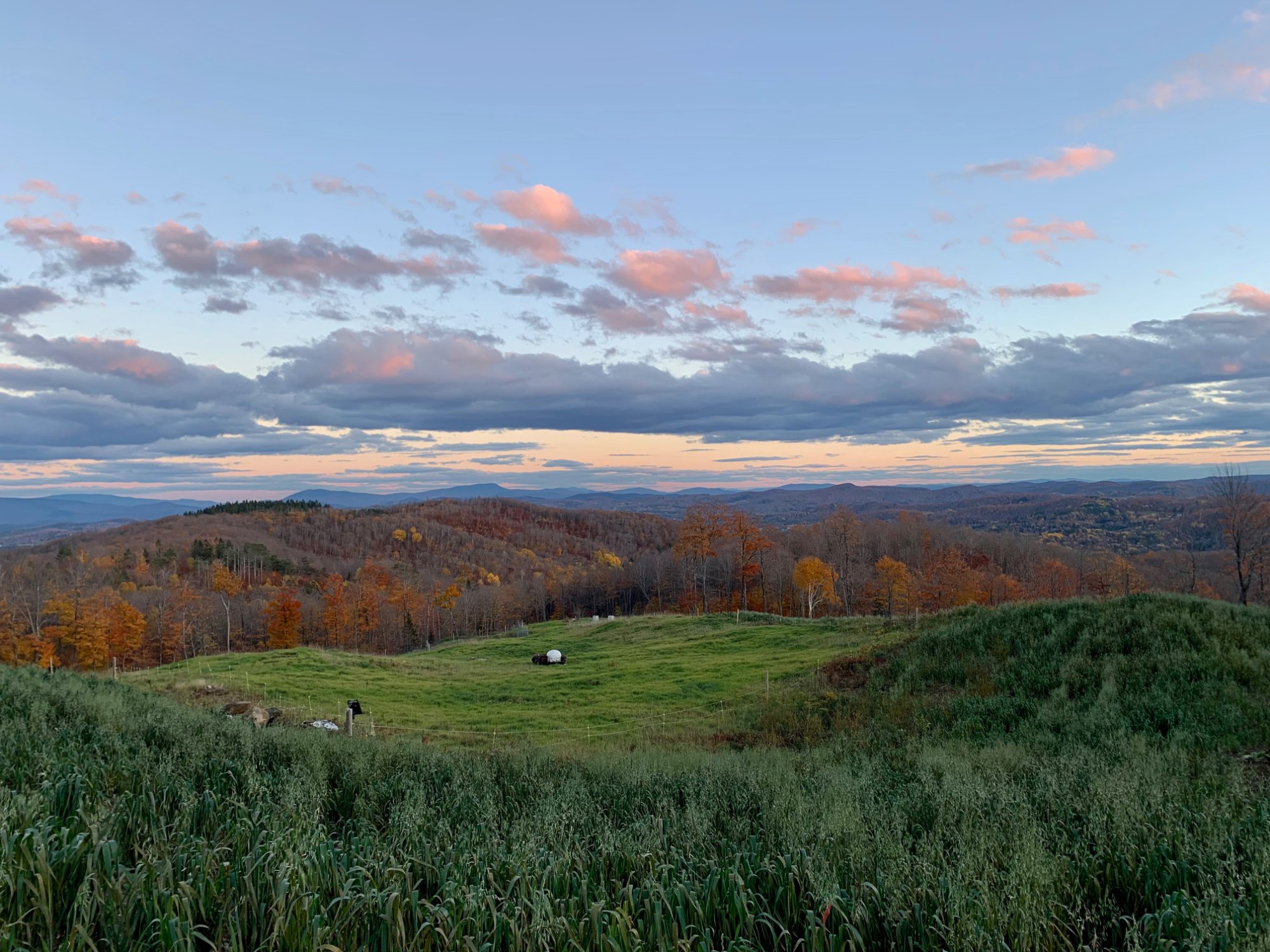 Panoramic Vermont hillside view at sunset with autumn foliage and open pasture — MacIsaac Highland events venue, 200+ acres